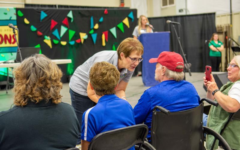 SDSU Extension Director Karla Trautman greet a group of volunteers at the 4-H volunteer hall of fame award ceremony.