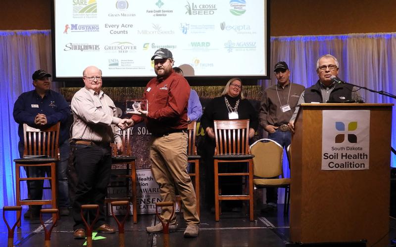 Anthony Bly, SDSU Extension Soils Field Specialist, receiving an award on-stage at the 2022 Soil Health Conference.