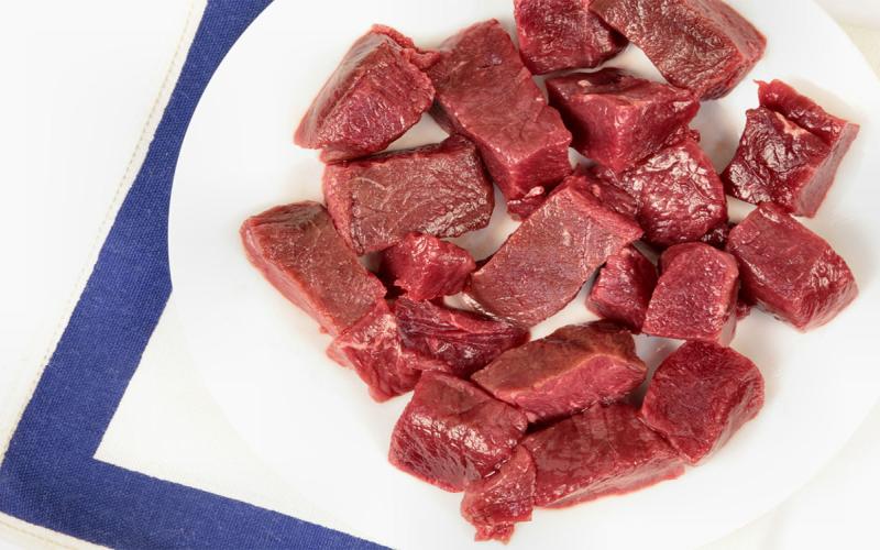 Cubes of lean venison on a plate.