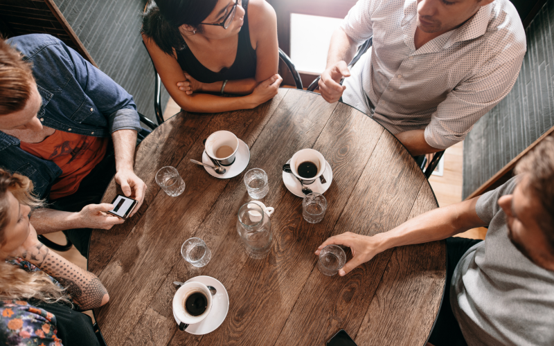 Group of people having discussion over coffee
