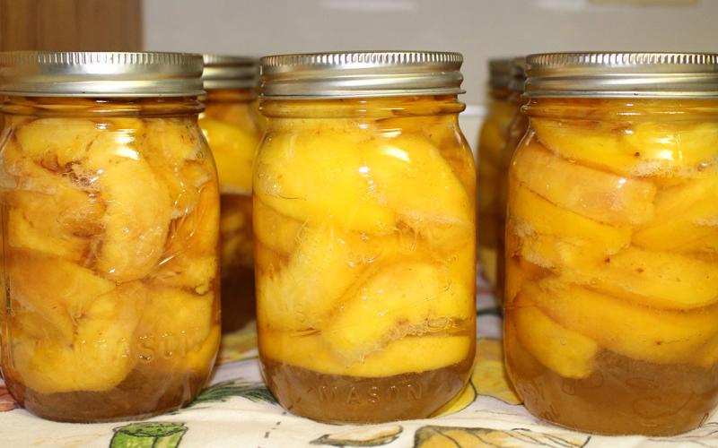 Jars of home-canned peaches.