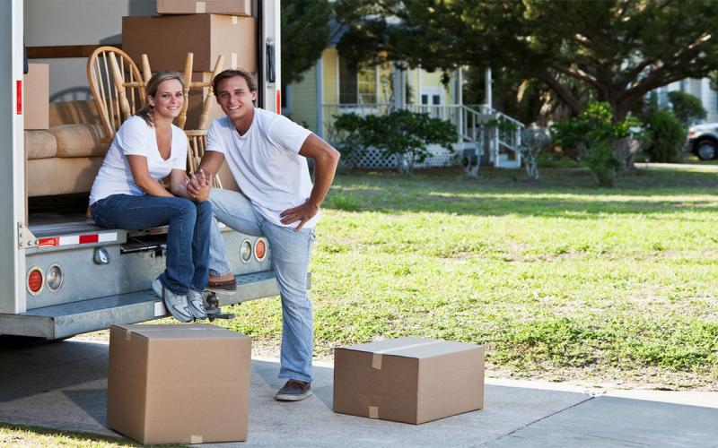 Young couple with moving truck.