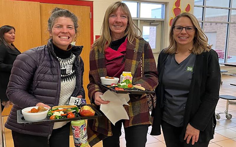 Local farm to school team members in a school cafeteria.