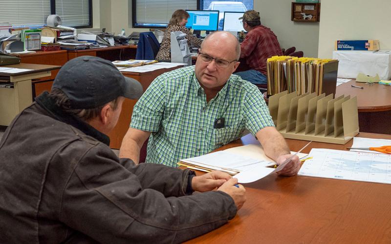 Producer reviewing an aid application with a USDA FSA agent.