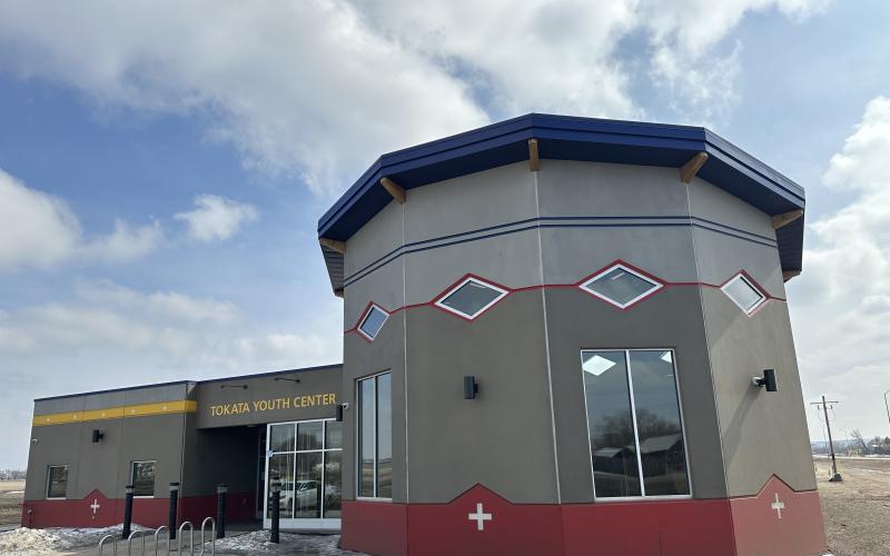 The Tokata Youth Center is pictured close up with blue sky and clouds in the background