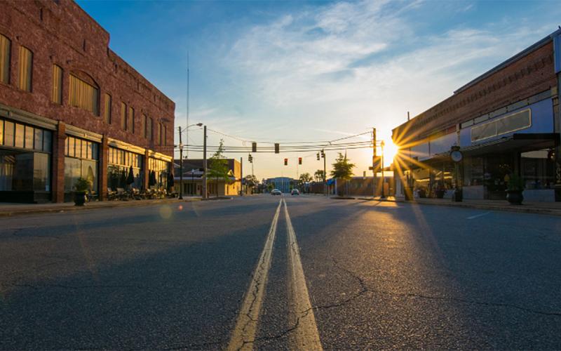 Sun rising over small town mainstreet.