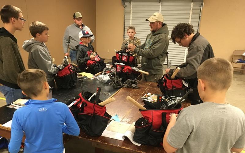 Group of youth learning how to make outdoor kits