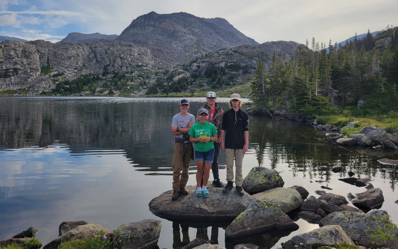 Group of youth standing in front of mountains