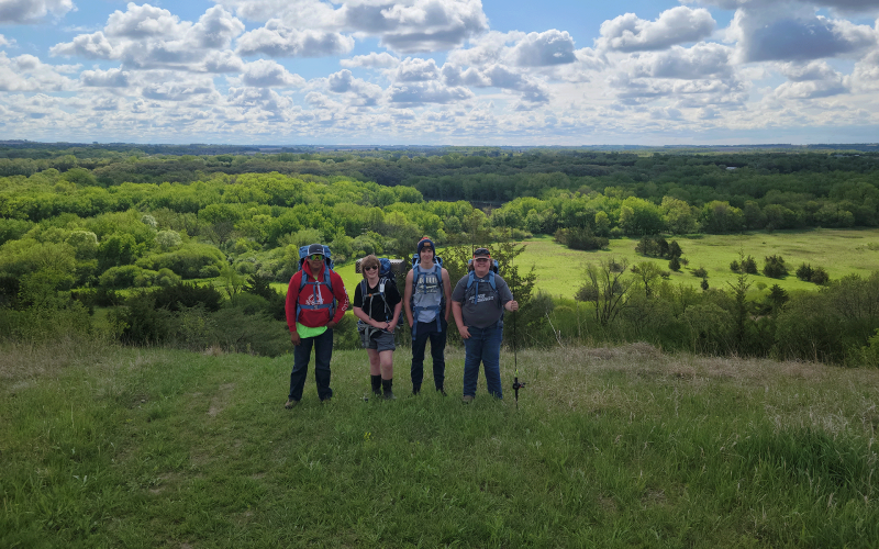 Group of youth standing atop a hill