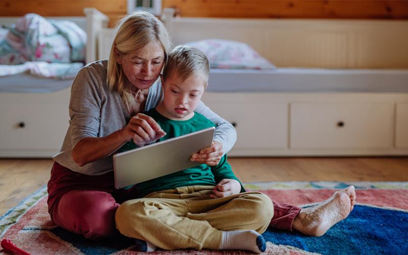 Grandmother and grandchild using a tablet.