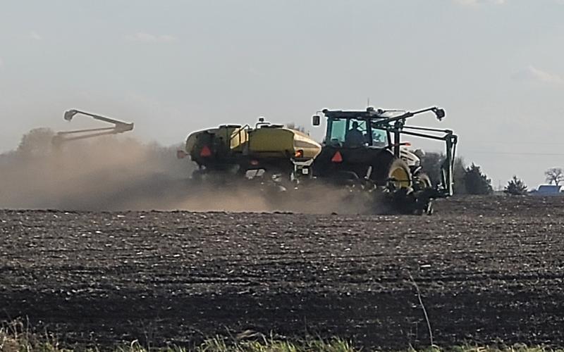 Tractor applying fertilizer to a field