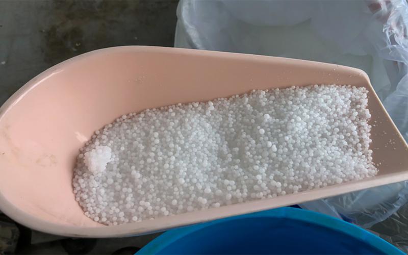 Urea supplement in a feed scoop.