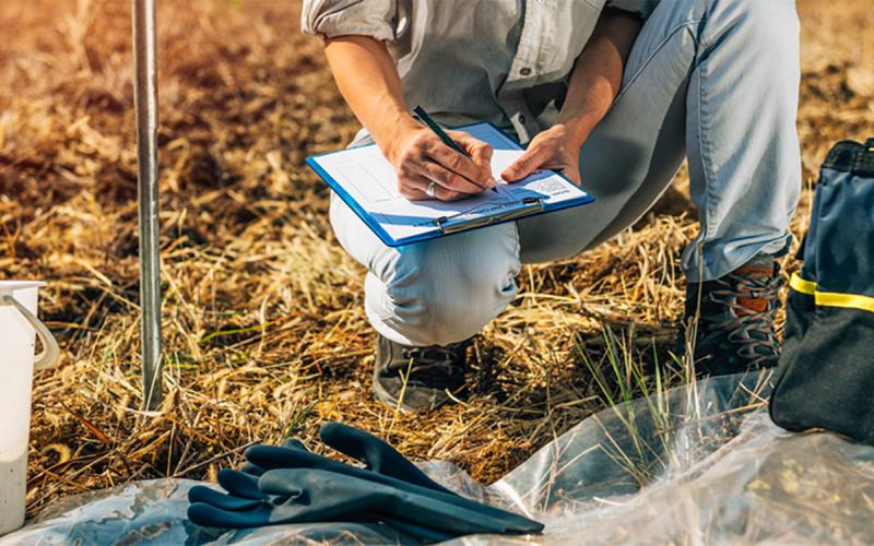 Soil scientist conducting an in-field soil test.