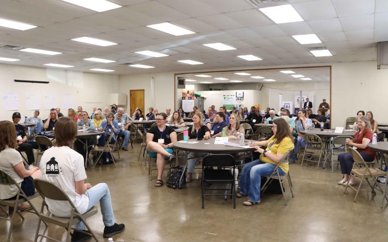 A room of people sit around tables and listen to the young entrepreneurs panel at the 2023 Energize conference in Wessington Springs