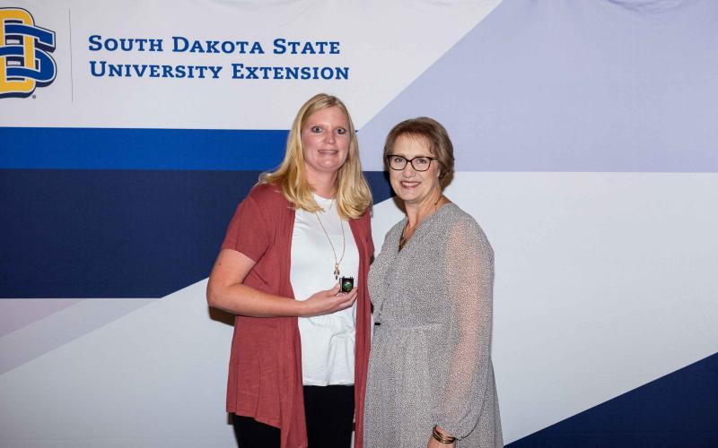 Jennifer Hayford receives a pin for 10 years of service from Karla Trautman