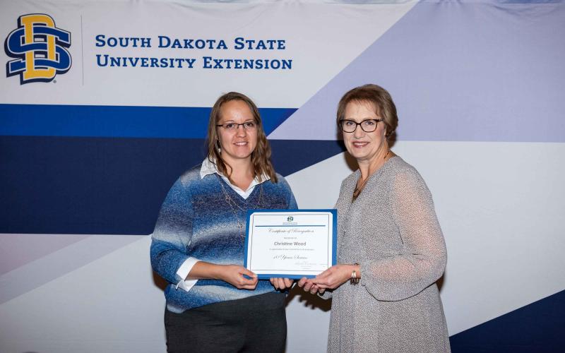 Christine Wood receives a certificate from Karla Trautman