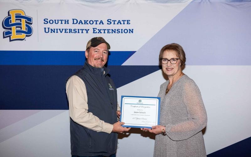 Jason Schoch receives a certificate for 10 years from Karla Trautman