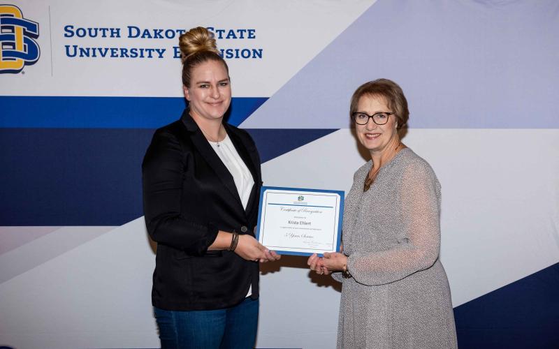 Krista Ehlert receives a certificate for 5 years of service from Karla Trautman