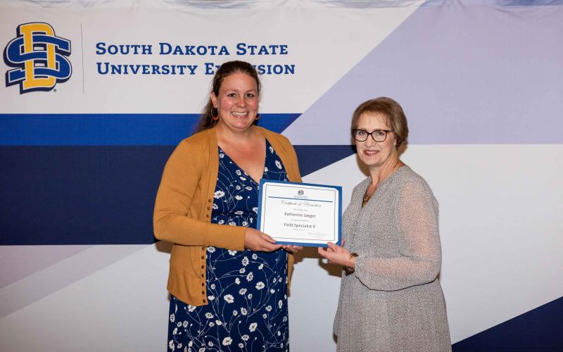 Katherine Jaeger accepts a certificate from Karla Trautman