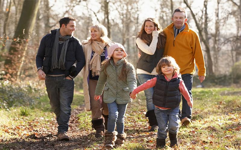 Three-generation family going for a walk in the countryside.