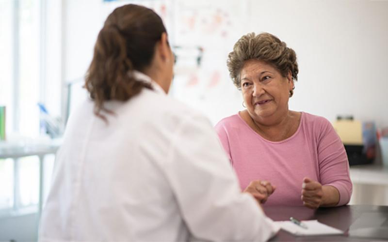 An older woman having a discussion with her doctor.