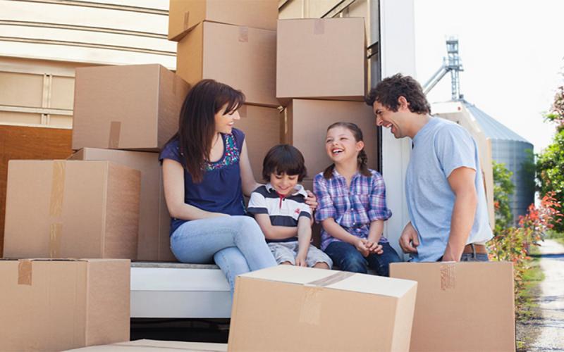 Multi-ethnic family unloading a moving truck.