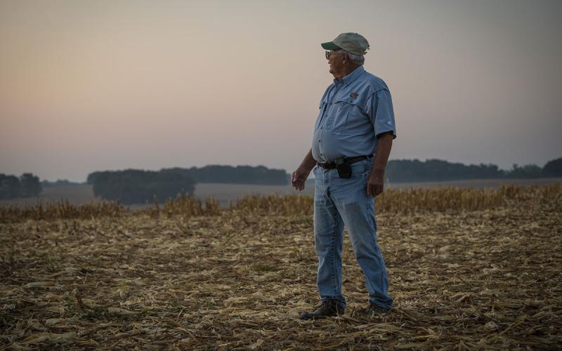 Farmer standing in a no-till field.