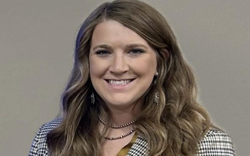 Erin DeHaan smiles at the camera for a portrait