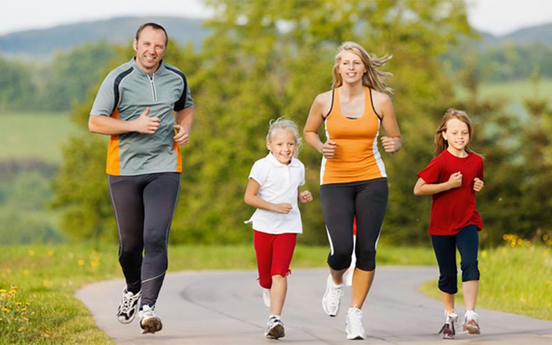 Family jogging together on a rural exercise trail.