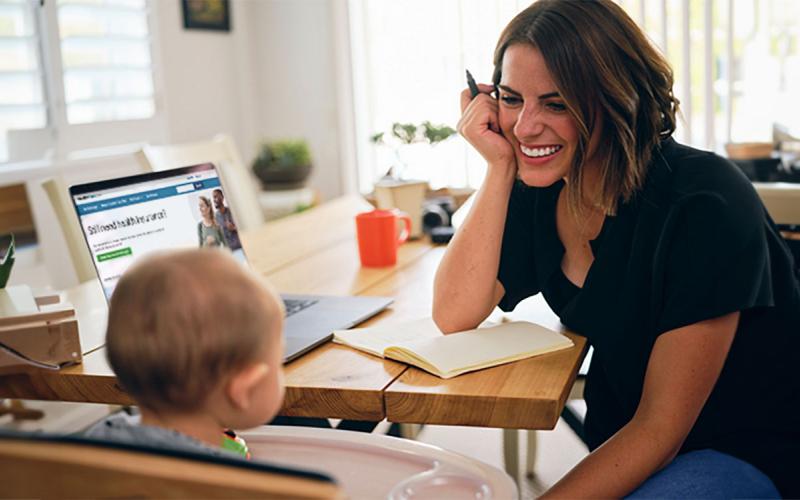 Mother and son at a computer with the health insurance marketplace on-screen.