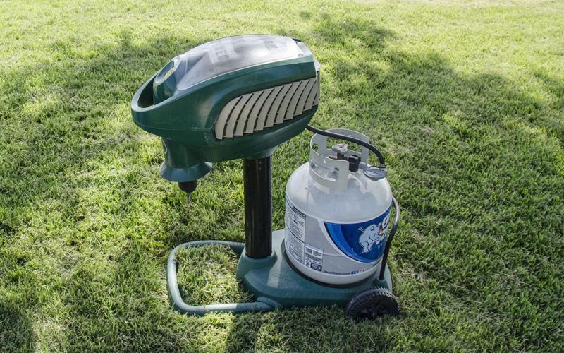 A carbon dioxide mosquito trap set up on a lawn.
