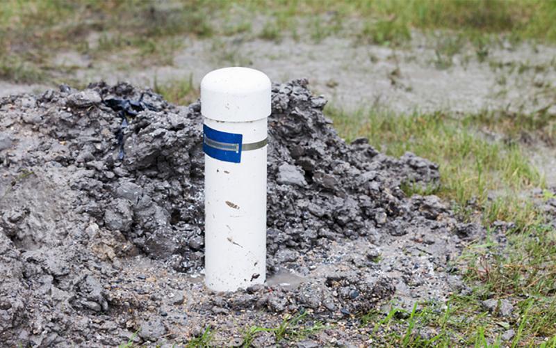 Residential water well in a flooded lawn.