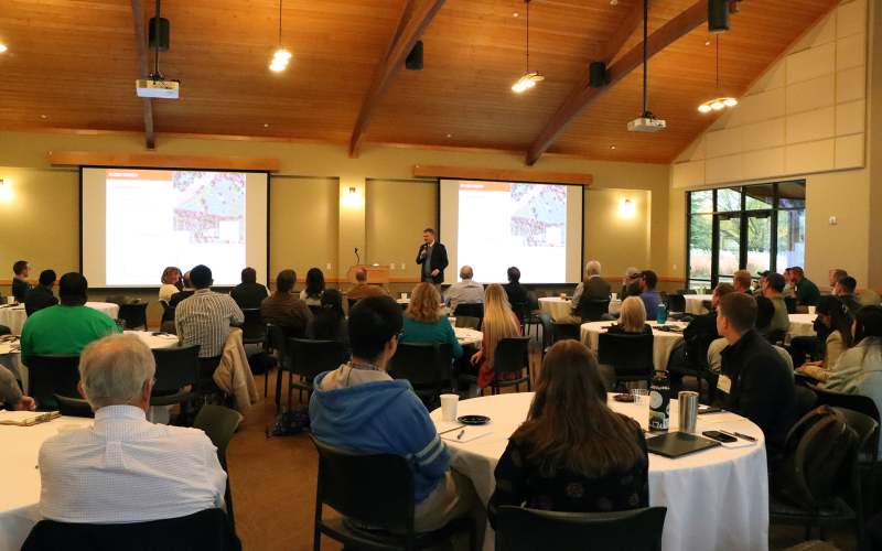 A group of people listening to a presentation