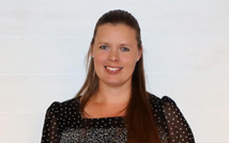 Sara Bauder holds up her award plaque