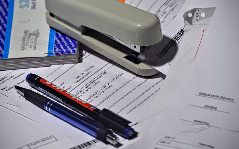 A stack of paperwork that needs to be organized.