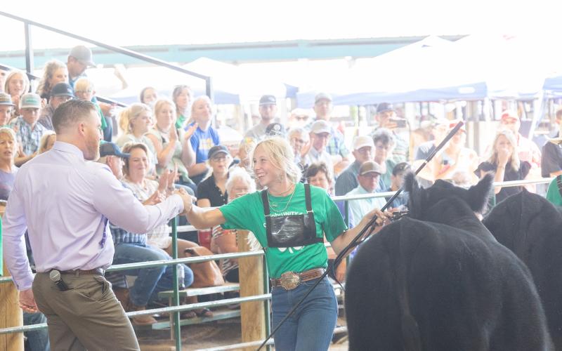Adult male shaking a teenage girl's hand during State Fair Adult male shaking a teenage girl's hand during State Fair