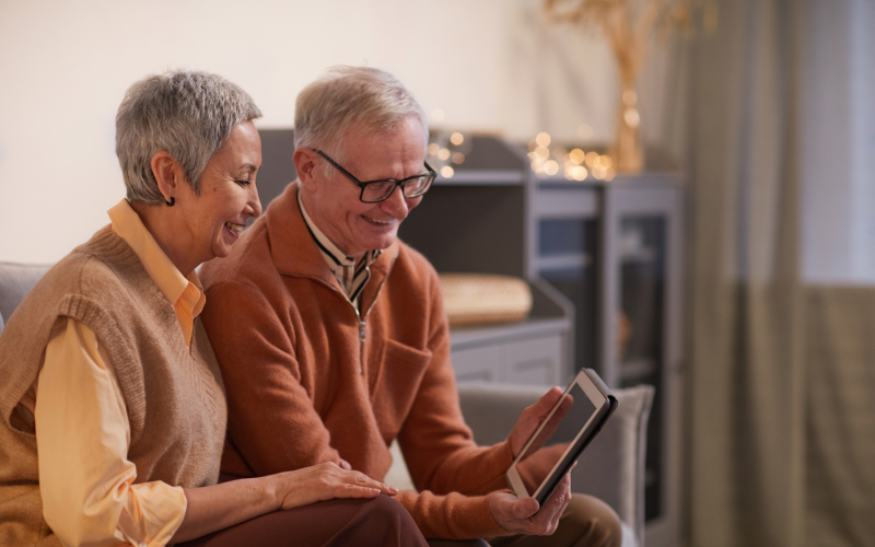 Two older adults looking at tablet