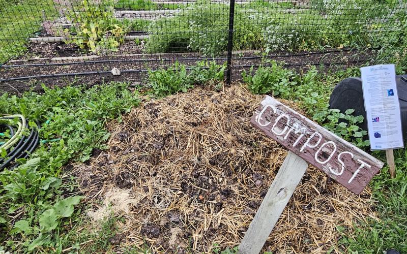A pile of soil and compost covered with straw