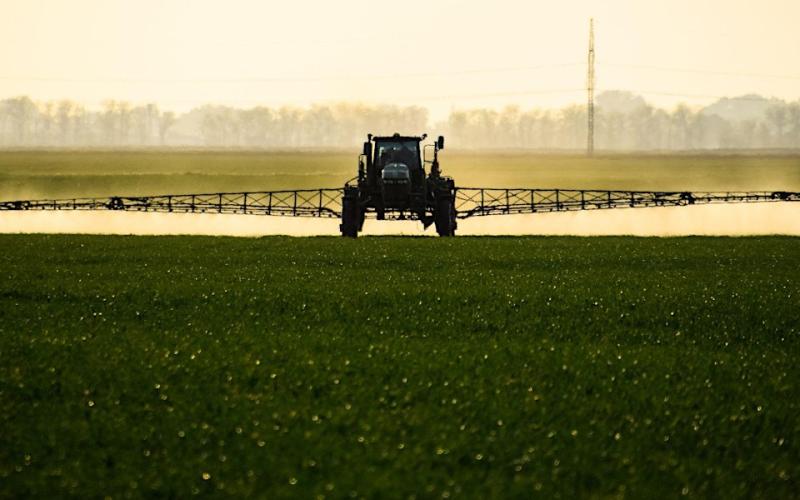 Sprayer applying pesticides to a field.