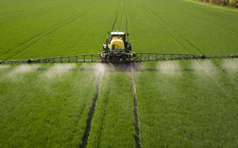Sprayer applying pesticides to a field.
