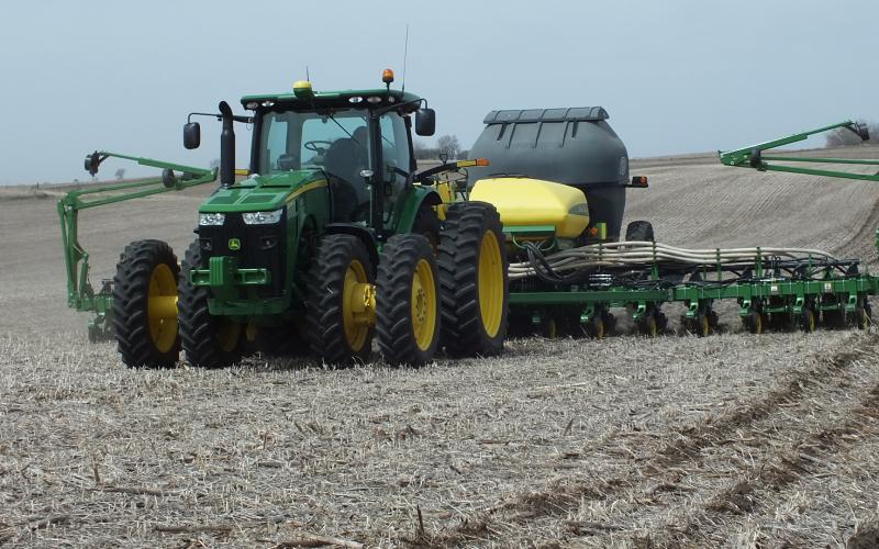 Tractor working a field after harvest