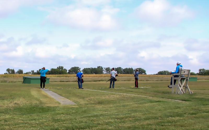 4-H youth and judge at a shotgun range.