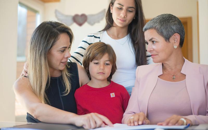Multi-generation family reviewing estate documents.
