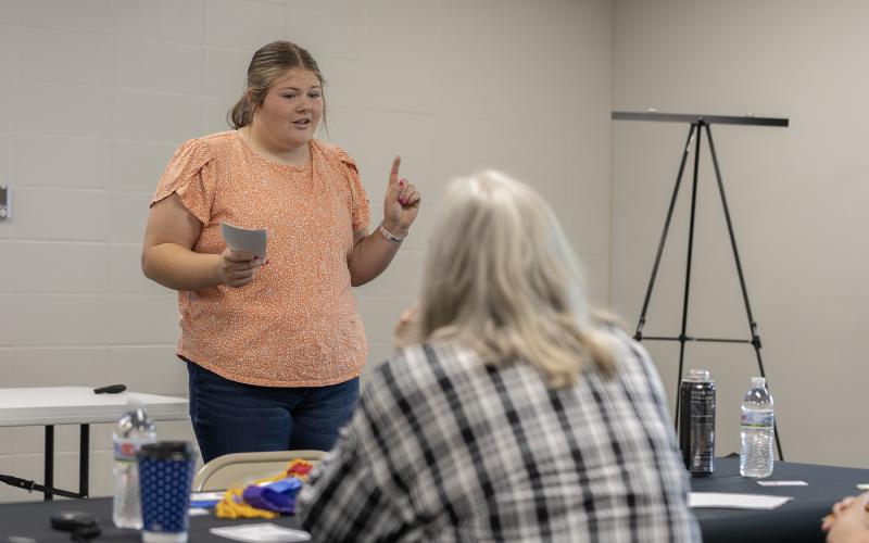 a girl giving a public presentation infront of a women judge