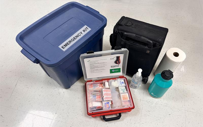 Collection of emergency supplies arranged on a floor.