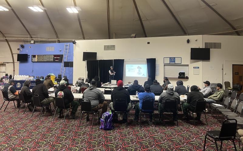 Group of people watching a presentation during at pesticide applicator training